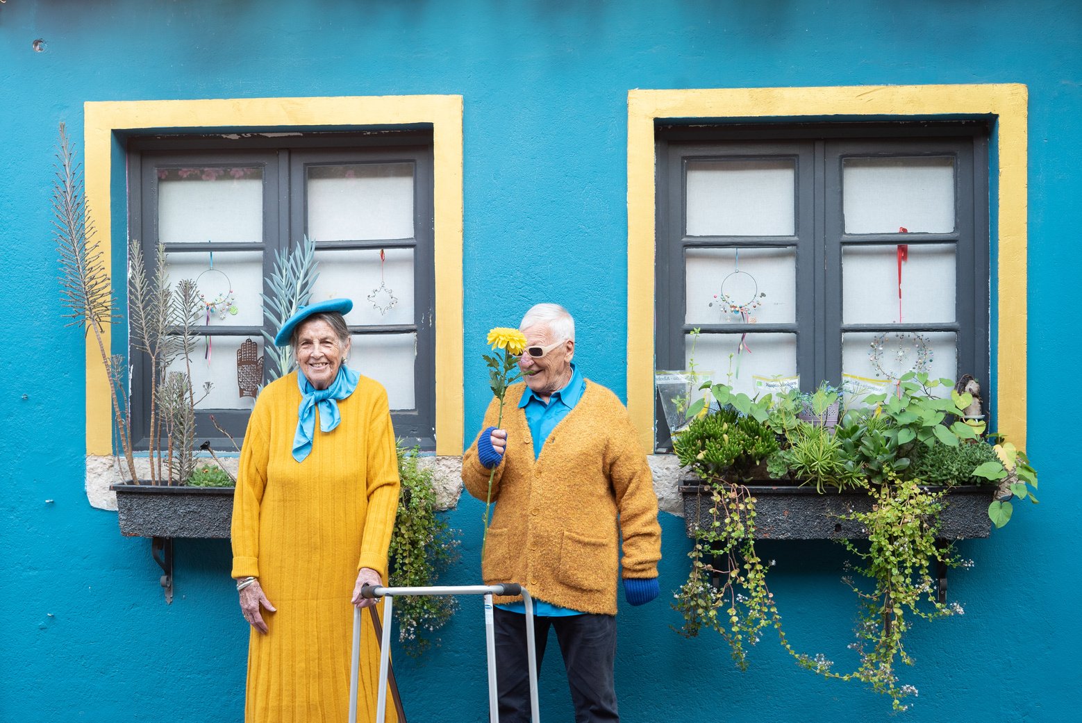 Stylish Elderly Couple with Walker and Cane